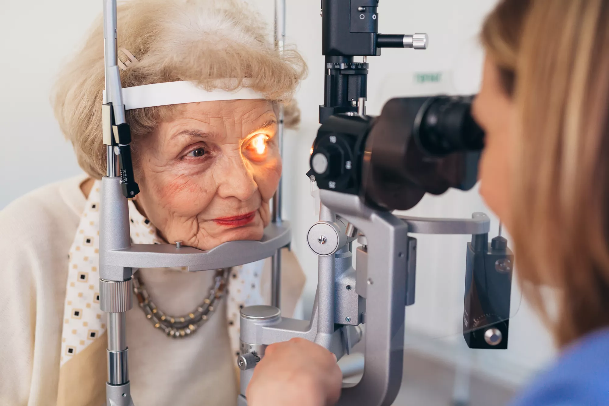 Elderly woman getting an eye exam.